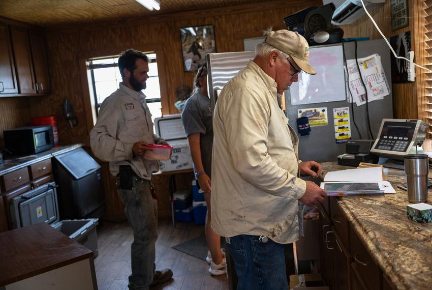 In his office at his cattle and grain company, Robert Fleming flips through a folder with a mix of spam and legitimate offers to install solar panels on his property on Tuesday, May 13, 2025, in Troy. 